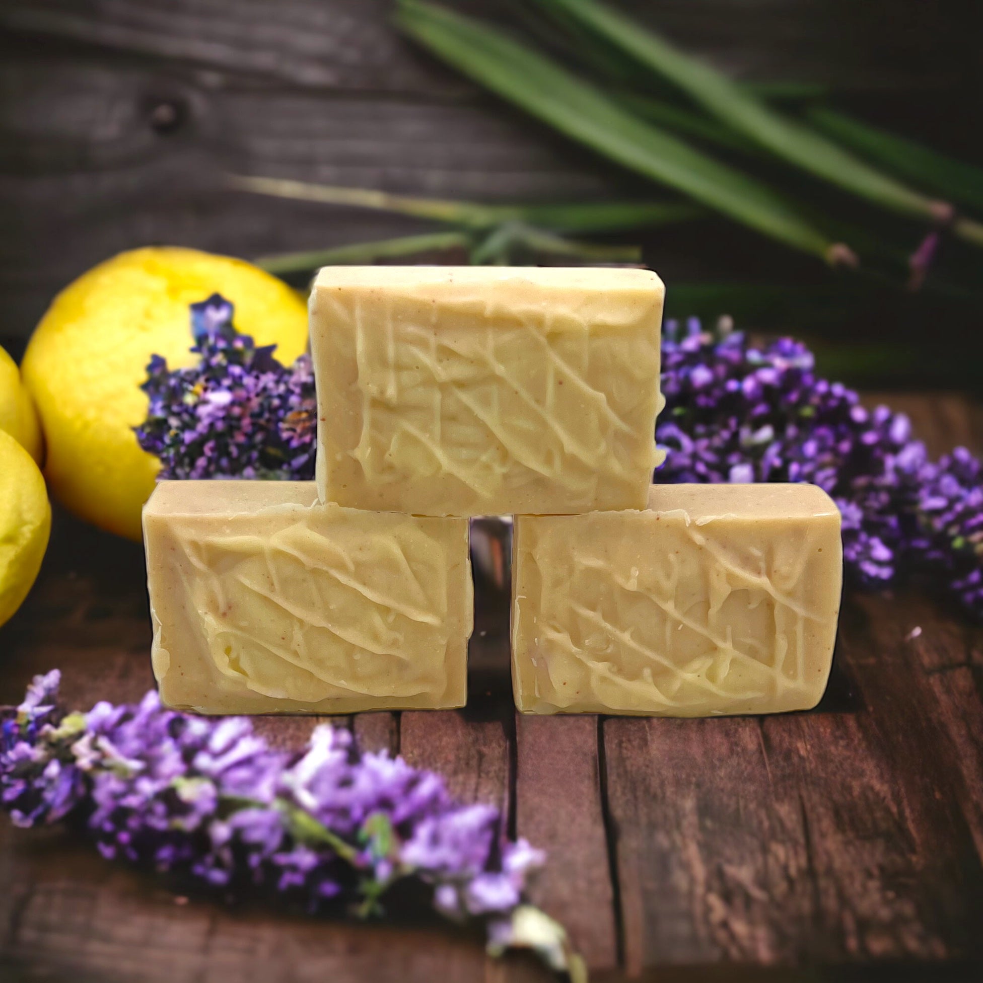 Three handcrafted soap bars stacked with a textured creamy surface.